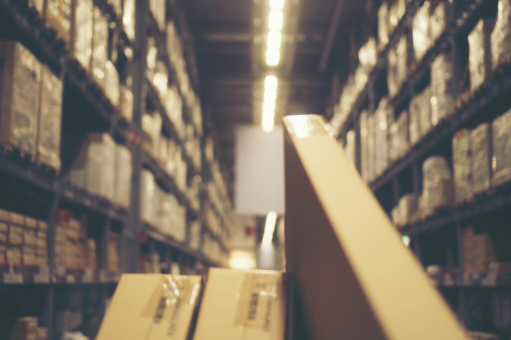 Blurred image of shelf in modern distribution warehouse or storehouse
